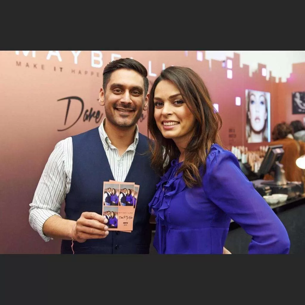 Guests holding their customised Mirror Photobooth print at a brand event